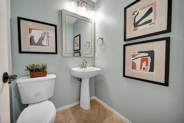 bathroom with tile patterned flooring and toilet