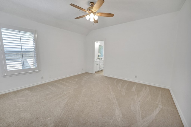 carpeted empty room with vaulted ceiling and ceiling fan