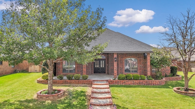 view of front of home with a front yard and french doors