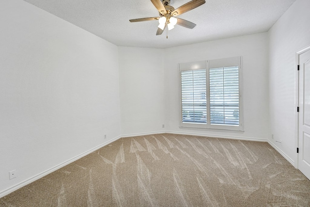 unfurnished room with a textured ceiling, carpet floors, and ceiling fan