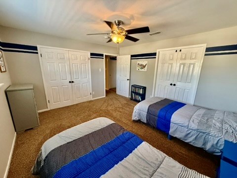 3302 Cord Dr, Midland, TX 79705 - bedroom featuring carpet flooring, two closets, and ceiling fan