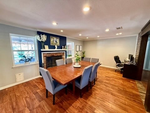 3302 Cord Dr, Midland, TX 79705 - dining room featuring a fireplace, crown molding, wood finished floors, healthy amount of natural light, and recessed lighting