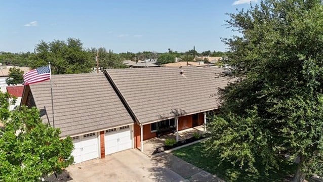 3302 Cord Dr, Midland, TX 79705 - view of side of property featuring an attached garage and concrete driveway