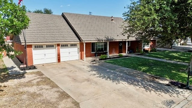 3302 Cord Dr, Midland, TX 79705 - view of front of property with a garage, concrete driveway, and a front yard