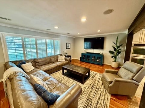 3302 Cord Dr, Midland, TX 79705 - living room featuring ornamental molding, wood finished floors, and recessed lighting