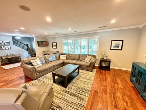 3302 Cord Dr, Midland, TX 79705 - living room featuring ornamental molding, stairway, wood finished floors, and recessed lighting