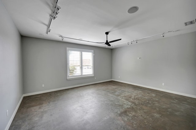 empty room featuring track lighting, ceiling fan, concrete flooring, and visible vents