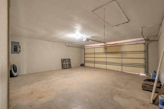 garage featuring electric panel and a garage door opener