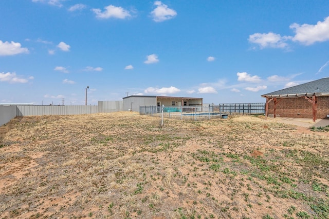 view of yard featuring an outdoor structure and fence