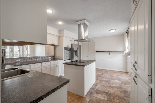 kitchen featuring island exhaust hood, stainless steel appliances, white cabinets, dark countertops, and a center island