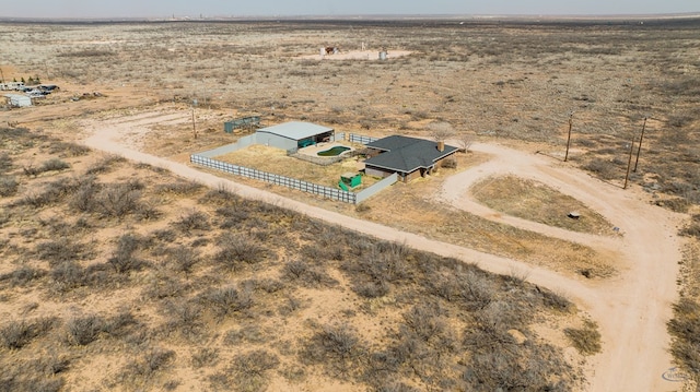 birds eye view of property featuring a desert view and a rural view