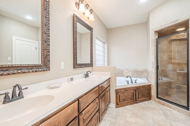 bathroom with vanity and independent shower and bath