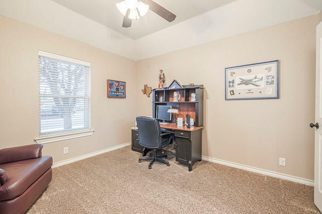 carpeted home office with vaulted ceiling and ceiling fan