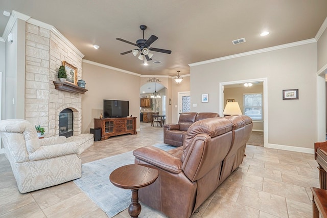 living room with crown molding, a stone fireplace, and ceiling fan with notable chandelier