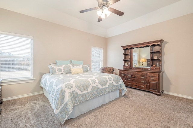 carpeted bedroom featuring multiple windows, lofted ceiling, and ceiling fan