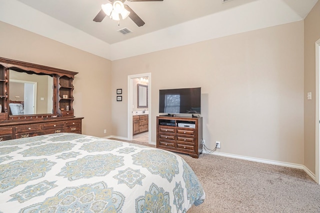 bedroom featuring connected bathroom, vaulted ceiling, light colored carpet, and ceiling fan