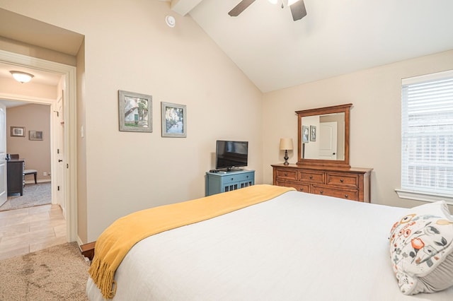 carpeted bedroom with ceiling fan and vaulted ceiling with beams