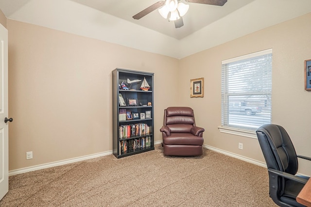 carpeted office space with ceiling fan