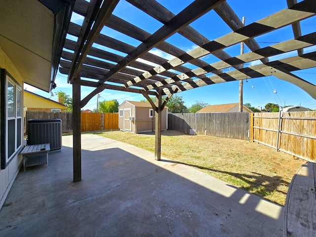 view of patio featuring central AC unit, a shed, a fenced backyard, and an outbuilding