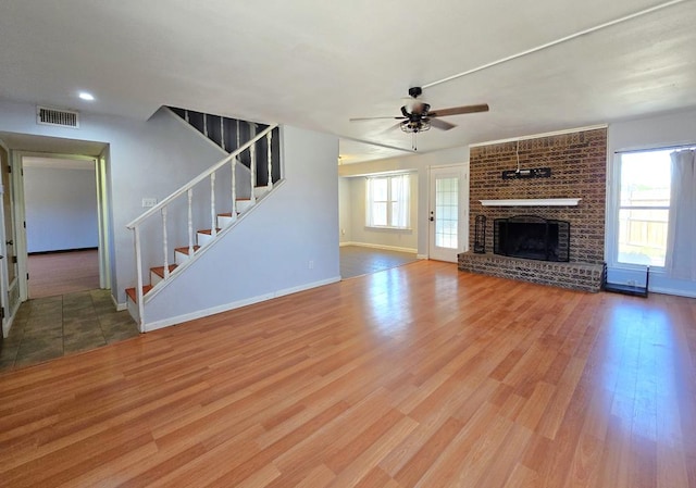 4515 Palmer Dr, Midland, TX 79705 - unfurnished living room featuring stairway, ceiling fan, wood finished floors, a fireplace, and recessed lighting