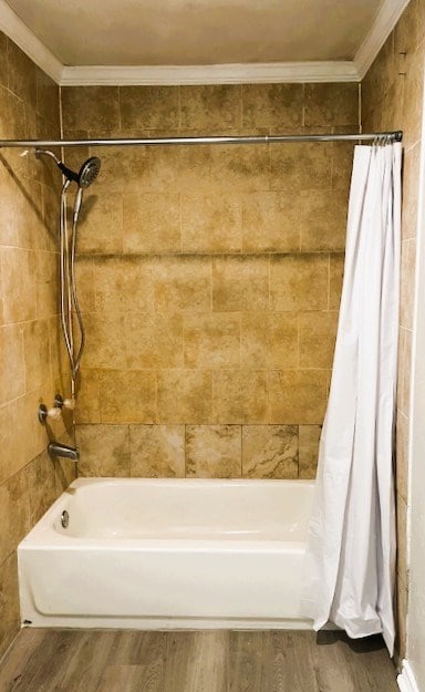 bathroom with shower / bath combo, wood finished floors, and crown molding