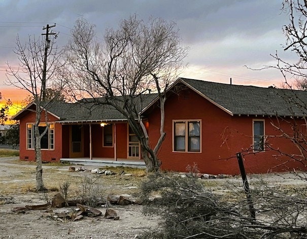 view of front of home with a shingled roof and crawl space