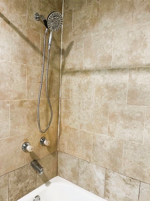 interior details with shower / washtub combination