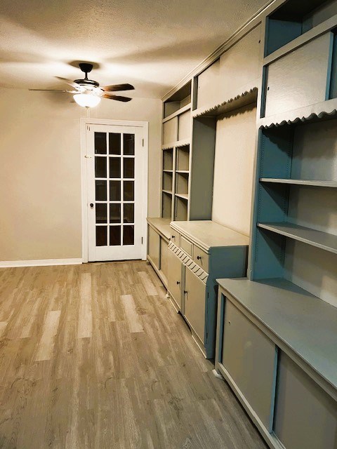 mudroom with a textured ceiling, wood finished floors, a ceiling fan, and baseboards