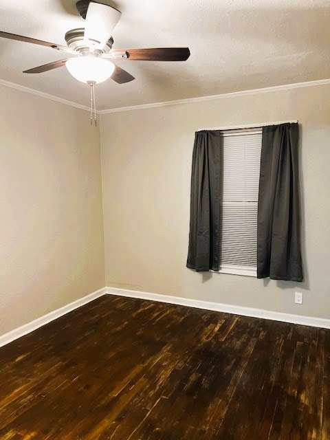 spare room featuring ornamental molding, wood-type flooring, a ceiling fan, and baseboards