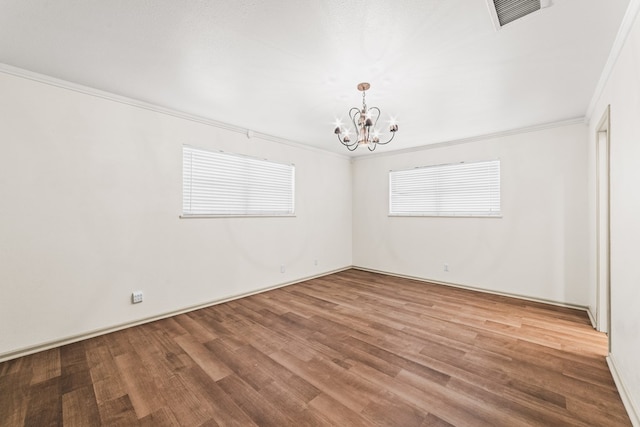 504 SW 19th St, Seminole, TX 79360 - spare room featuring a chandelier, ornamental molding, and wood finished floors