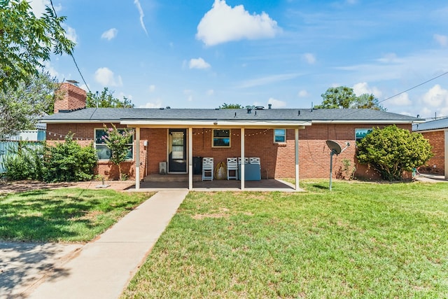 504 SW 19th St, Seminole, TX 79360 - rear view of house featuring brick siding, a yard, a patio, and a chimney