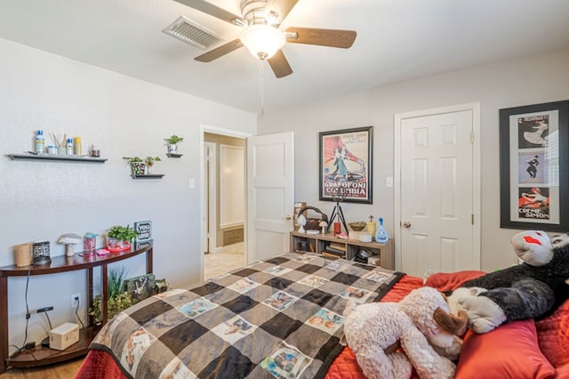 bedroom with visible vents, a ceiling fan, and wood finished floors