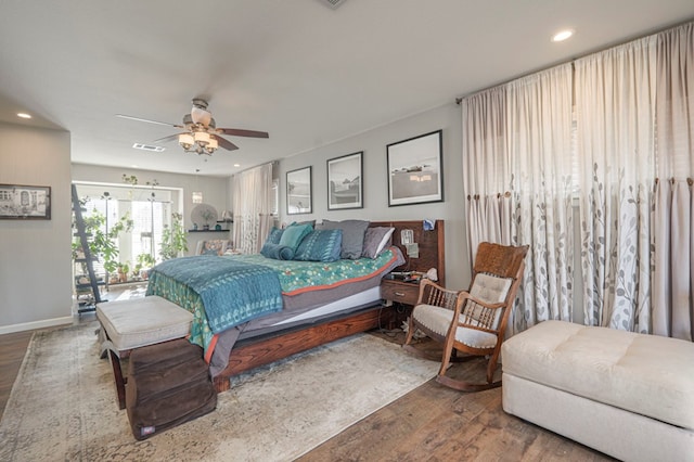 bedroom featuring ceiling fan, visible vents, baseboards, wood-type flooring, and recessed lighting
