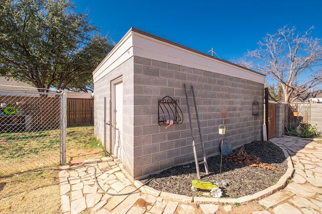 view of outbuilding featuring an outdoor structure and fence