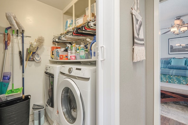 laundry area featuring laundry area, wood finished floors, and washing machine and clothes dryer