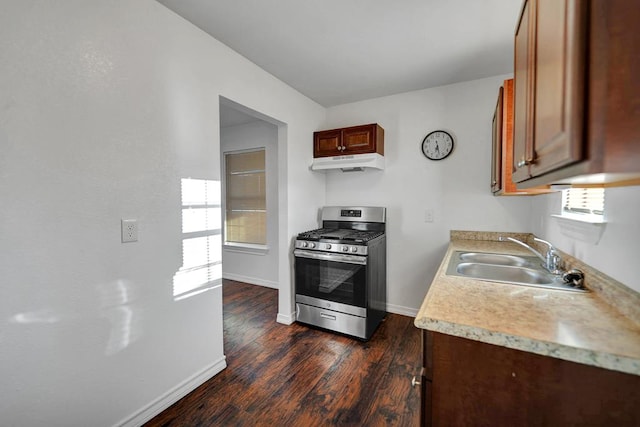 kitchen with gas range, sink, and dark wood-type flooring