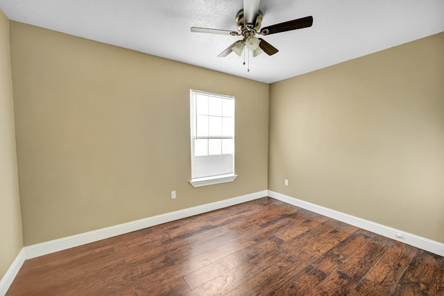 spare room featuring ceiling fan and dark hardwood / wood-style floors