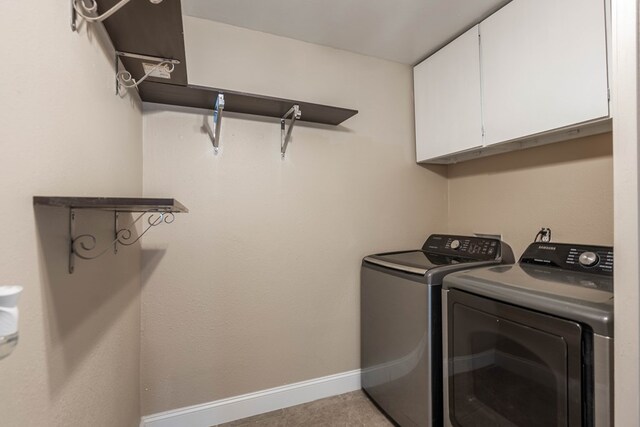 1829 Petroleum Dr, Odessa, TX 79762 - laundry area with cabinet space, washer and clothes dryer, and baseboards