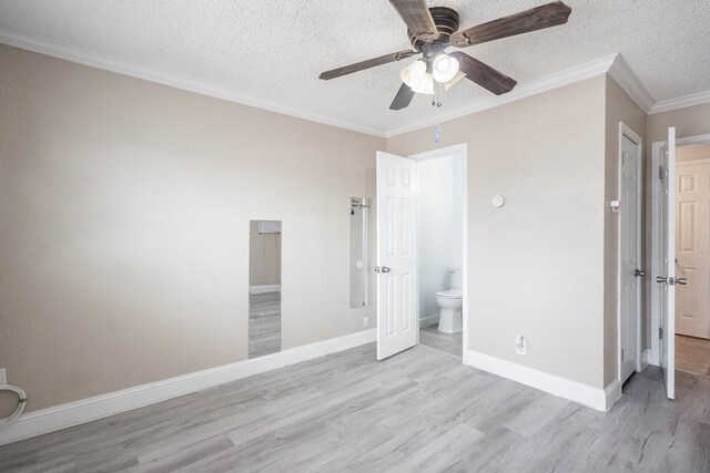 1829 Petroleum Dr, Odessa, TX 79762 - unfurnished bedroom with wood finished floors, a textured ceiling, baseboards, crown molding, and ensuite bathroom