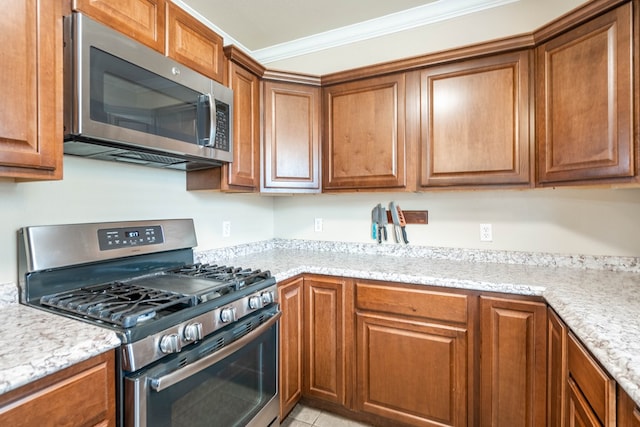 1829 Petroleum Dr, Odessa, TX 79762 - kitchen with stainless steel appliances, ornamental molding, and brown cabinets