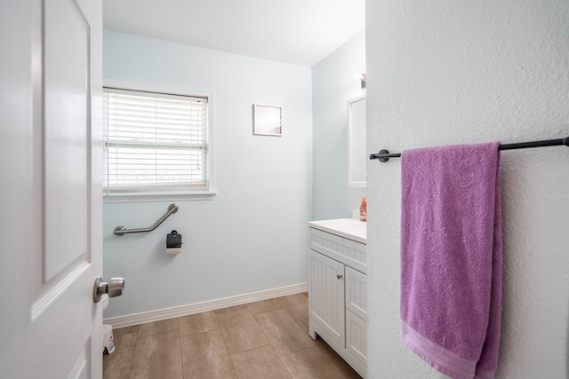 1829 Petroleum Dr, Odessa, TX 79762 - bathroom with vanity, wood finished floors, and baseboards