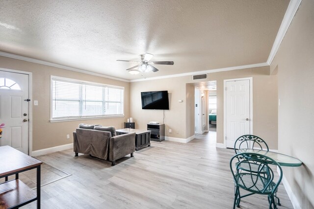1829 Petroleum Dr, Odessa, TX 79762 - living room with a ceiling fan, light wood-style flooring, healthy amount of natural light, a textured ceiling, and crown molding