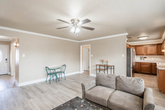 1829 Petroleum Dr, Odessa, TX 79762 - living area featuring ceiling fan, crown molding, light wood-type flooring, and baseboards