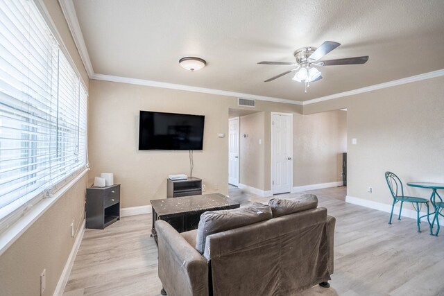 1829 Petroleum Dr, Odessa, TX 79762 - living room with ceiling fan, light wood-style flooring, ornamental molding, and baseboards