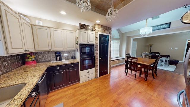 kitchen featuring a notable chandelier, light wood-style floors, backsplash, visible vents, and black appliances