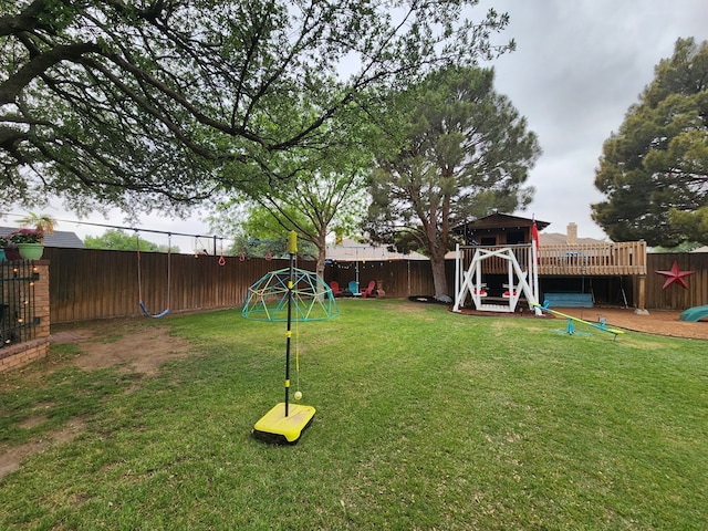 view of yard with a fenced backyard and a playground