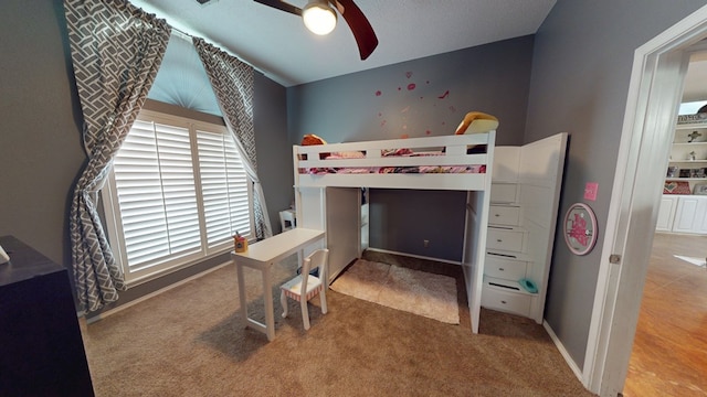 bedroom with carpet floors, a ceiling fan, and baseboards
