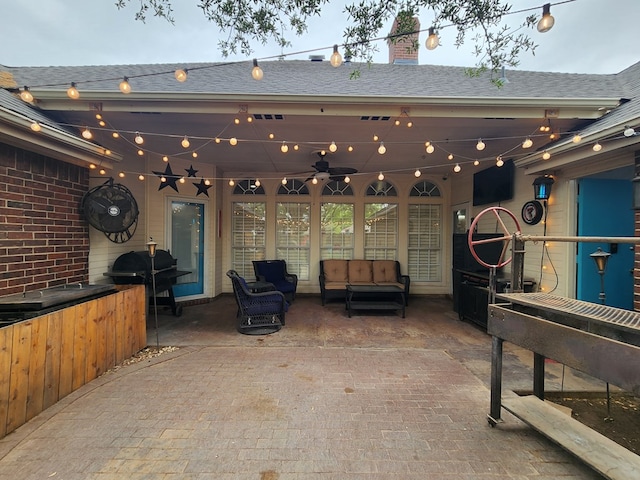 exterior space with visible vents, ceiling fan, and an outdoor living space