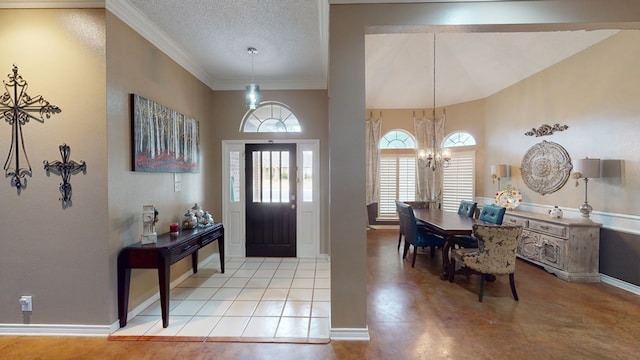 foyer entrance with baseboards, ornamental molding, a textured ceiling, and a chandelier