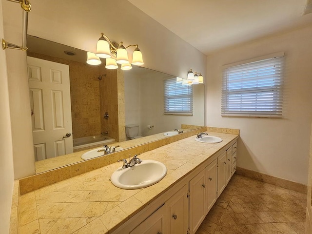 full bathroom featuring vanity, a chandelier,  shower combination, and toilet